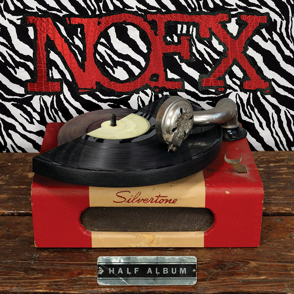 A broken Black Vinyl LP sits on a red Silvertone turntable on a wooden table. Behind it, zebra-print and bold red NOFX branding reference the NOFX double album. A metal plate in front reads HALF ALBUM EP. Brand Name: NOFX.