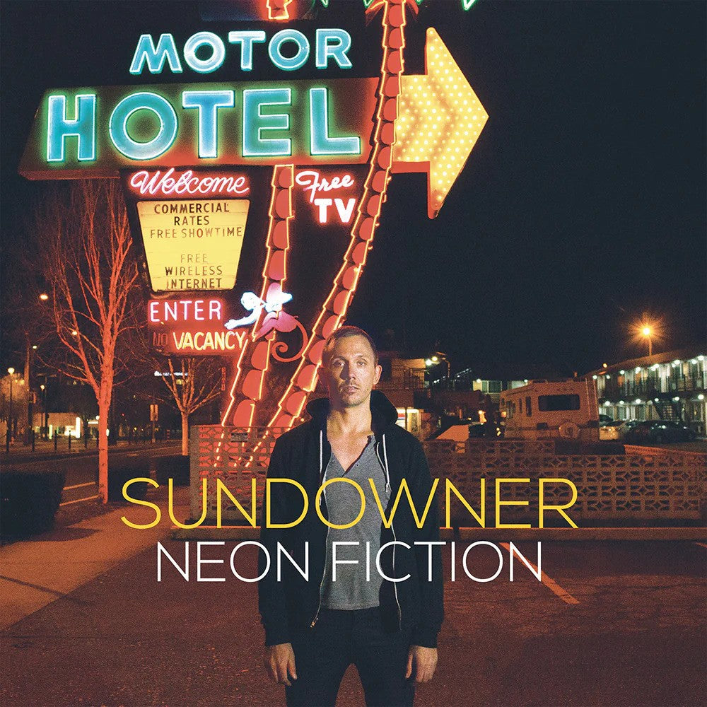 A man stands before a glowing retro motel sign at night. Neon letters spell Motor Hotel, capturing the moody vibes of Sundowner. Text on the image reads: Sundowner Neon Fiction.