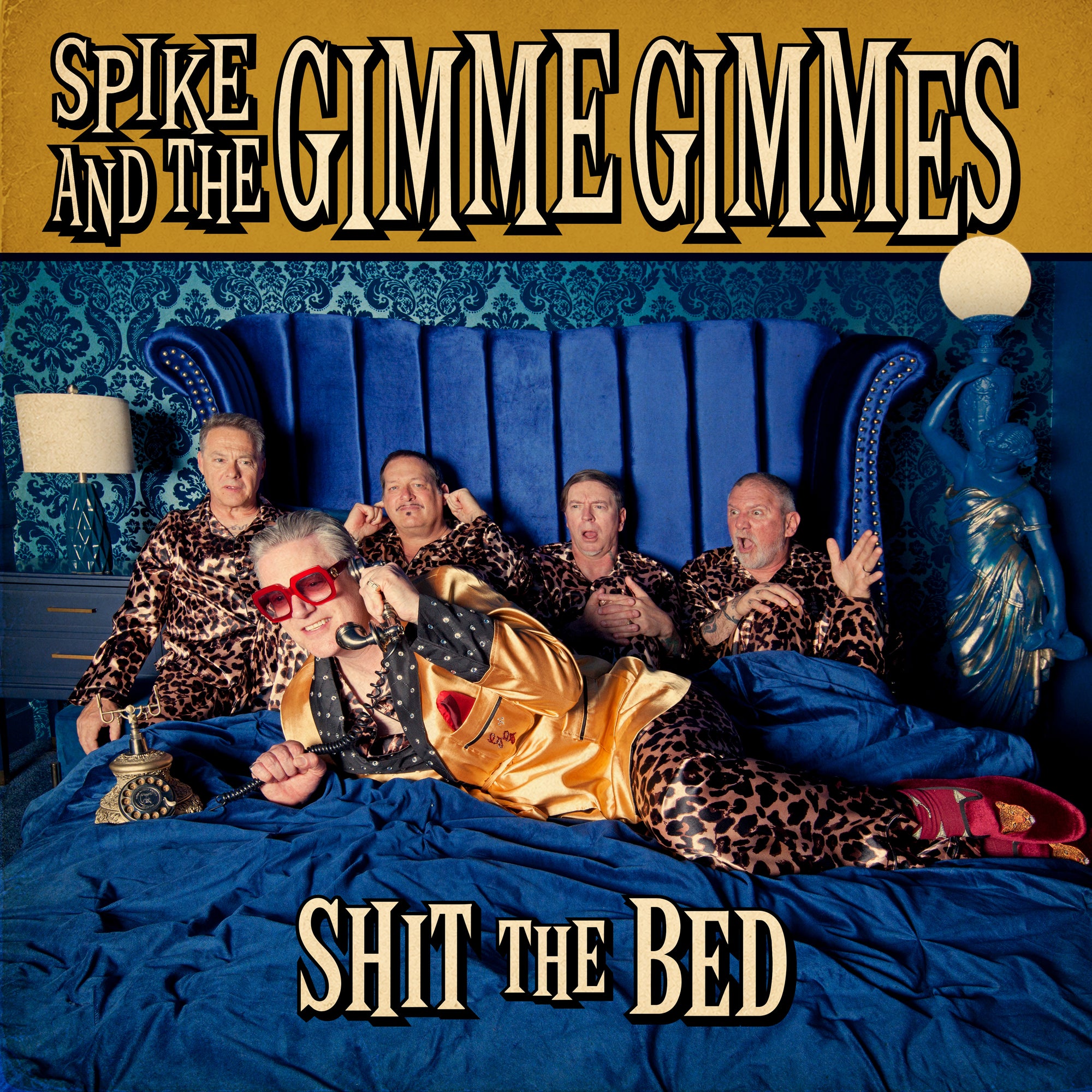 Five people in matching leopard-print outfits lie on a blue bed with vintage phones. The background has blue patterned wallpaper. Large text reads SPIKE AND THE GIMME GIMMES and SHIT THE BED. This eye-catching scene is the perfect cover for their limited edition vinyl, pressed on a Brown Splatter LP and housed in a striking 12″ jacket.