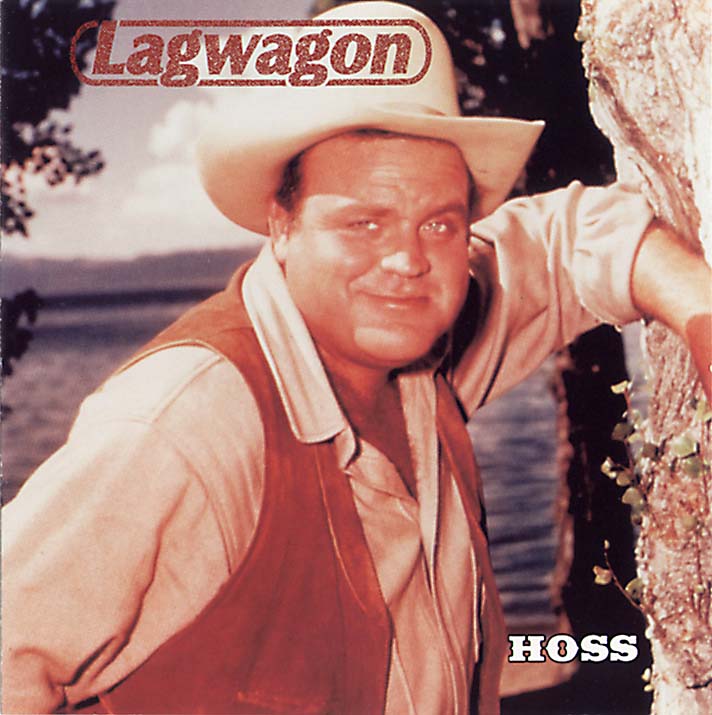 A man wearing a cowboy hat and vest leans against a wooden fence, grinning, with trees and water in the background. The brand name Lagwagon appears on the image, giving it the look of a limited edition vinyl album cover.